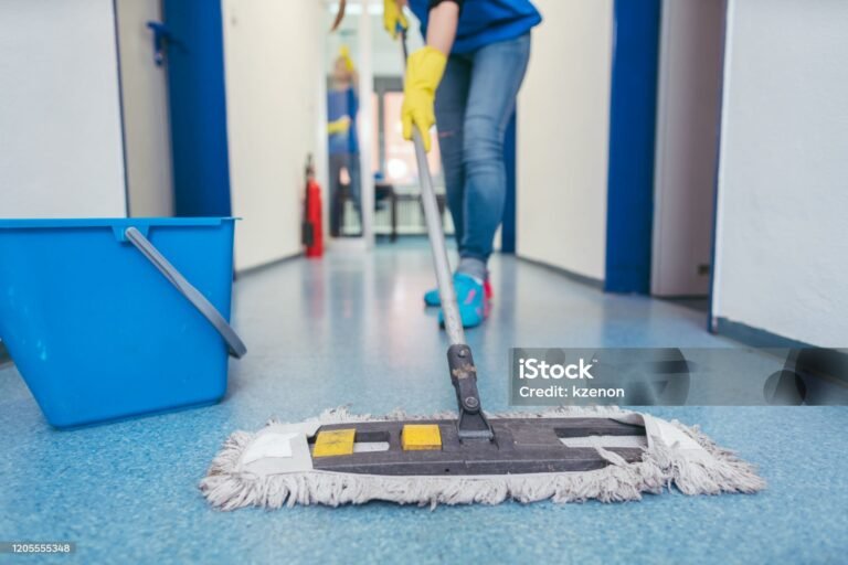 close up of cleaners moping the floor of a hall